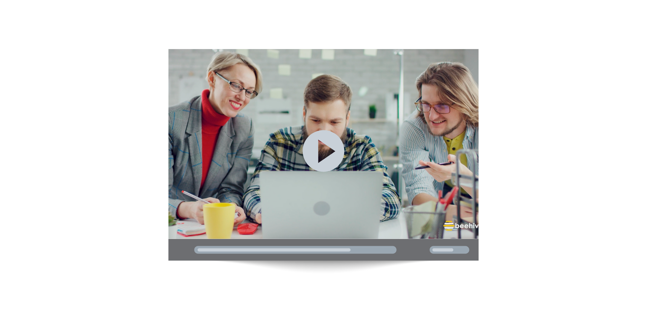 Still frame from Beehive’s corporate video showing a collaborative team working on a laptop, highlighting company culture and creative teamwork.